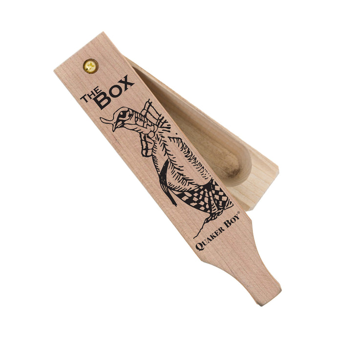 Quaker Boy The Box wild turkey call, featuring a sleek design and natural wood finish, ideal for attracting wild turkeys in outdoor hunting settings.