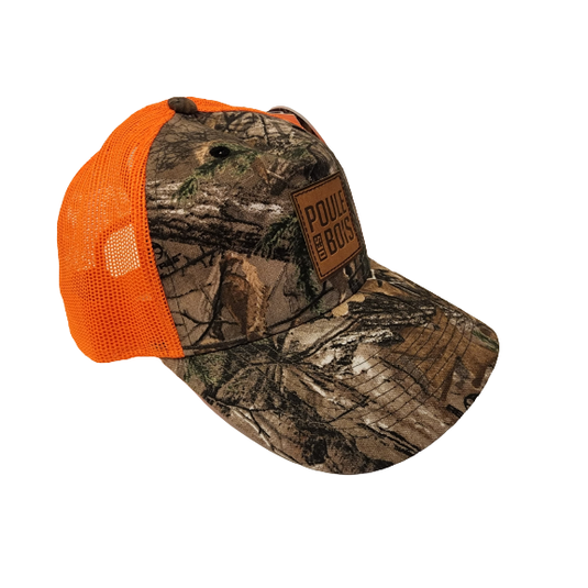 A vibrant camo-orange cap with a unique tufted design, paired with a whimsical illustration of a woodland hen, showcasing a blend of nature and playful fashion.