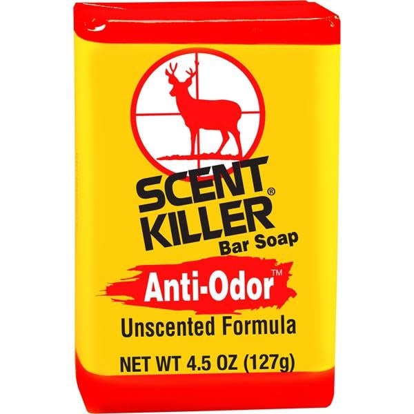 Wildlife Research Center scent killer bar soap displayed on a natural wooden surface, surrounded by greenery, emphasizing its eco-friendly and wildlife-safe attributes.