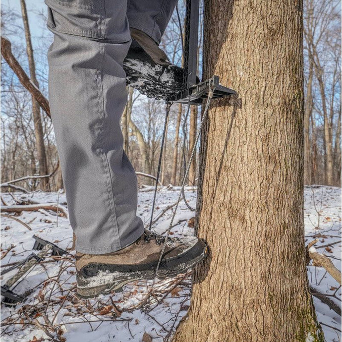 Latitude Outdoors Amsteel Single Step Aider hanging from a tree branch, showcasing its durable construction and lightweight design, ideal for enhancing climbing and hunting experiences.