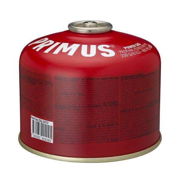 Primus camping stove with a 230g Bouteille de Butane Power Gas canister, set against a scenic outdoor backdrop.
